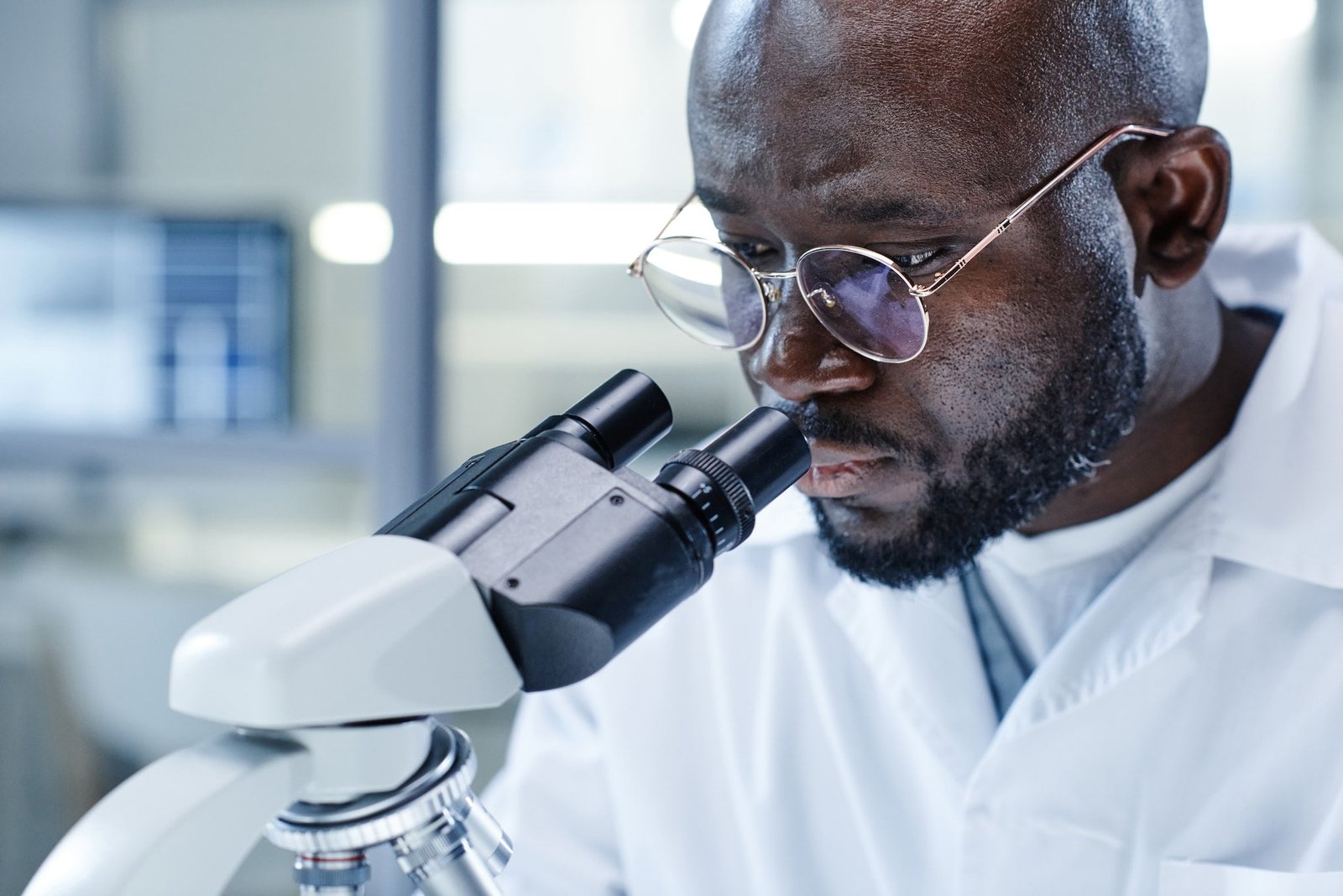 Man working with microscope at the lab